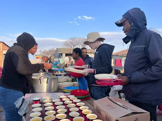 Sponsor visiting an NGO feeding scheme