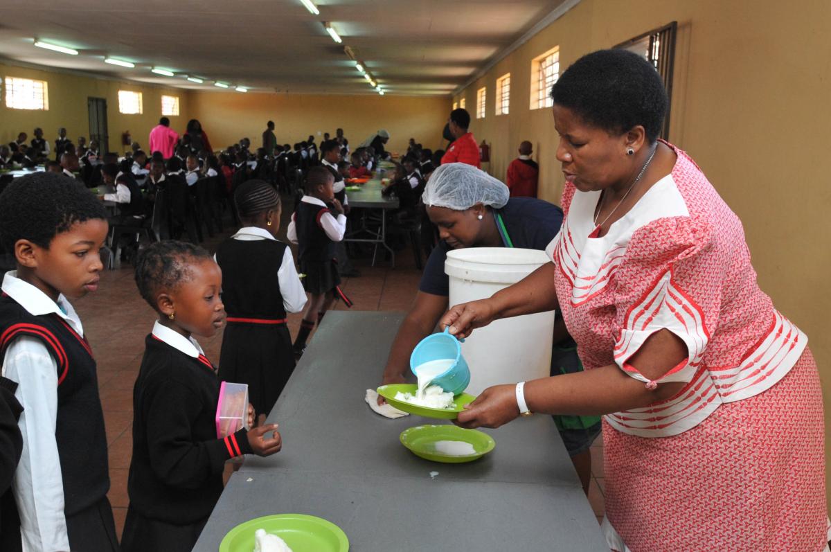 Youth packing food parcels for a school programme